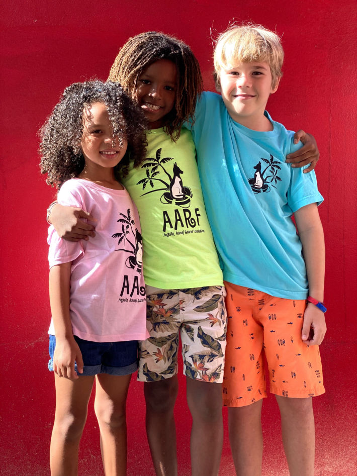 Three Junior Volunteers wearing AARF merchandise