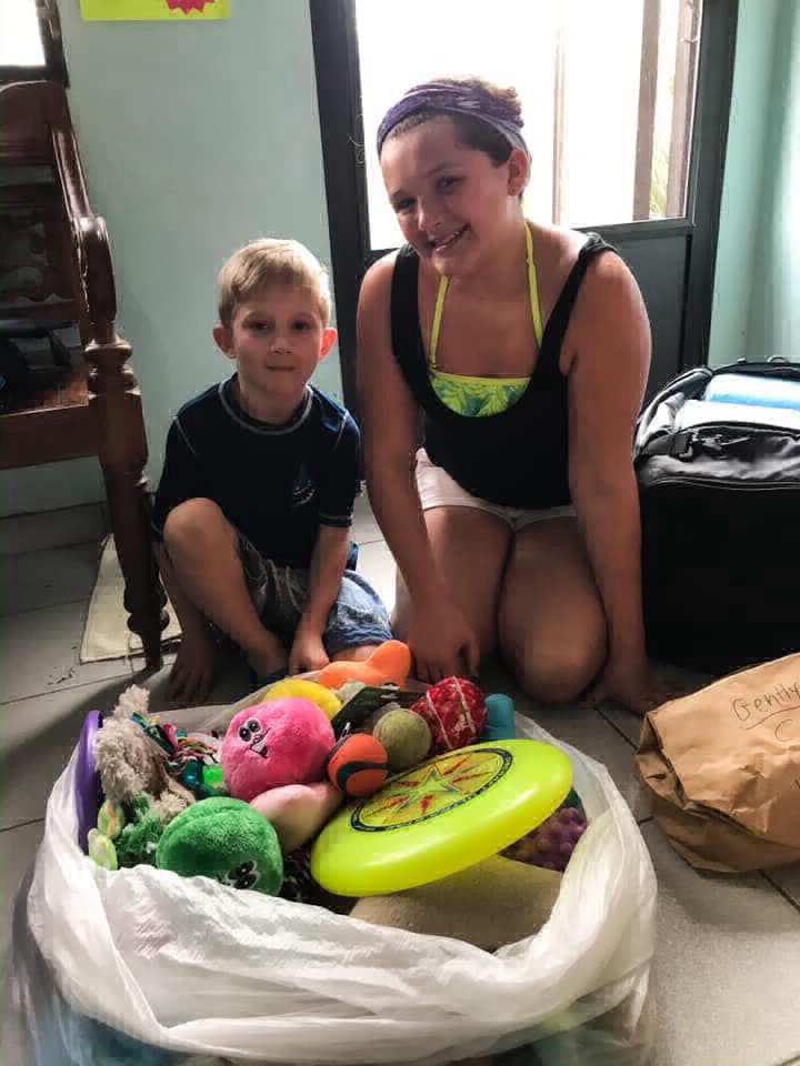 A young boy and girl donate pet toys