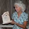 Althea holds up her Volunteer of the Year for 2010 award